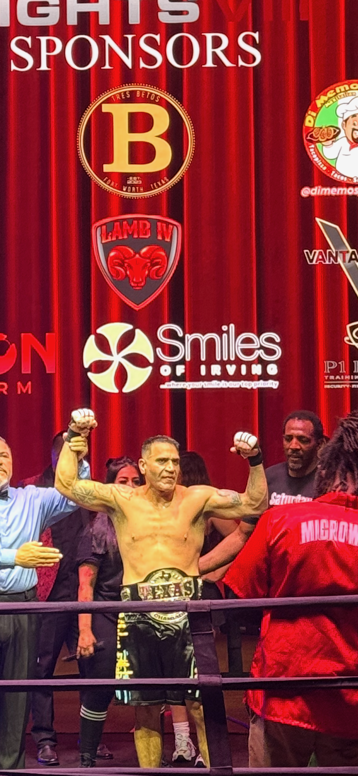 Francisco Rodriguez celebrating Texas Cruiserweight Championship victory with arms raised in the ring - Empire Boxing DFW trainer Plano Dallas